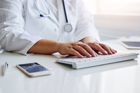 Female doctor working with her computer in medical officeの写真素材