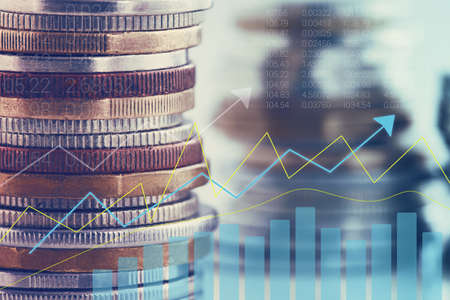 A stack of coins with an investment or savings chartの写真素材