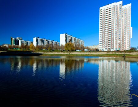 Apartment buildings mirrored in pond at autumn, Chertanovo Centralnoe, Moscowのeditorial素材