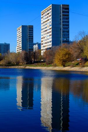 Apartment buildings mirrored in pond at autumn, Chertanovo Centralnoe, Moscowのeditorial素材