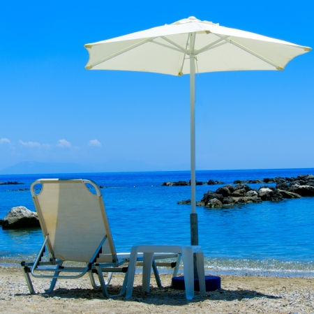 Sun Lounger and Parasol on a Beachの写真素材