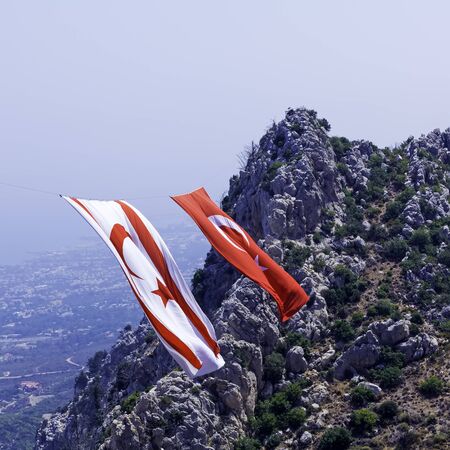 Enormous Turkey and North Cyprus flags between mountains near Saint Hilarion castle, Kyrenia mountain range, North Cyprusの写真素材