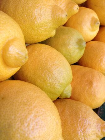 Many yellow lemons on tableの素材