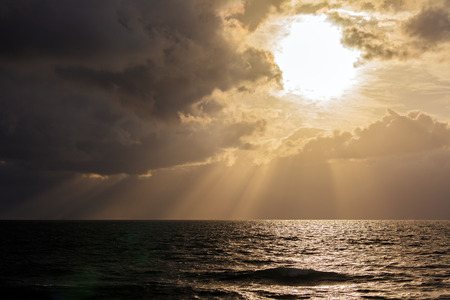 Dramatic Light with Sun Rays and Heavy Clouds above Mediterranean Sea near Caesarea Maritima, Israelの写真素材