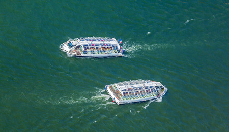 Tourist boat swimming Seine - aerial view from Eiffel Tower, Paris, France