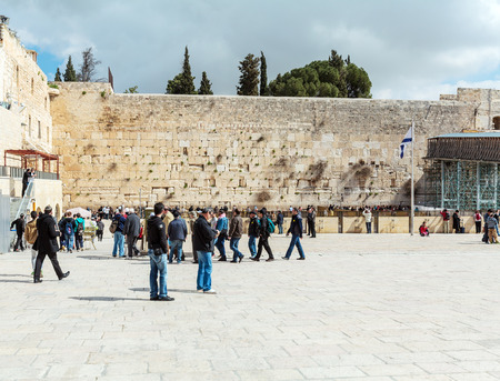 JERUSALEM, ISRAEL - FEBRUARY 17, 2013: People praying near Western Wall of Temple