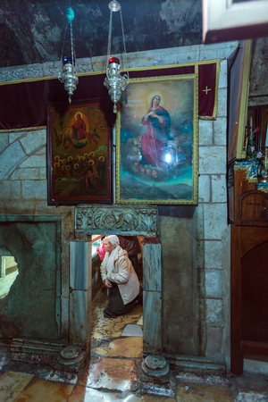 JERUSALEM, ISRAEL - FEBRUARY 16, 2013: Tourists entering sarcophagus in tomb of the Virgin Mary at Kidron Valleyのeditorial素材