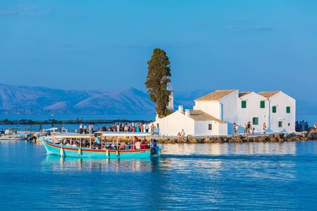 CORFU, GREECE - JULY 9, 2011: Tourists walking around Vlacherna monastery in Kanoni villageのeditorial素材