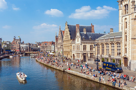 GHENT, BELGIUM - APRIL 6, 2008:  A lot of students sitting on the waterfront of river Leie along Graslei streetのeditorial素材
