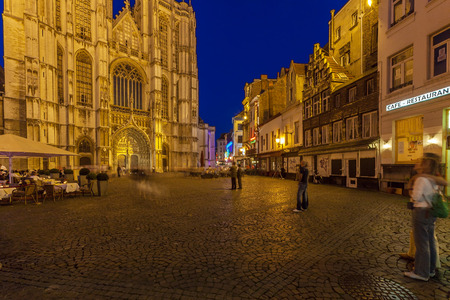 ANTWERP, BELGIUM - APRIL 6, 2008: Tourists eating at outdoor cafes Handschoenmarkt in front of the Cathedral of Our Lady at nightのeditorial素材