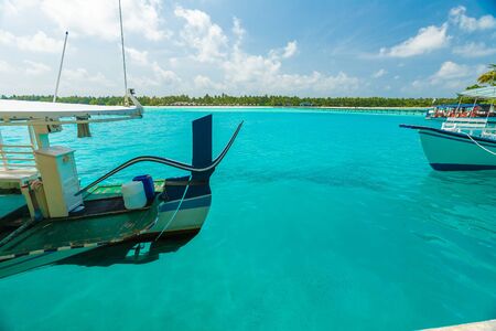 Traditional boats and the pier beside tropical island, Maldivesの写真素材