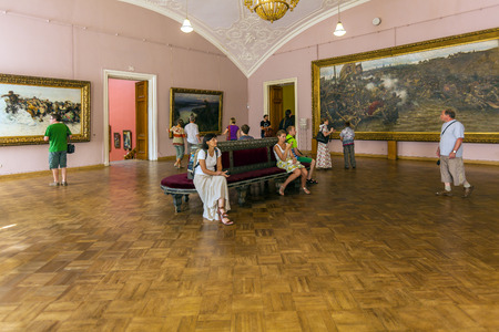SAINT PETERSBURG, RUSSIA - JULY 26, 2014:  Visitors to the interior of the Russian Museum next to the picture Surikov "Taking a snow town"のeditorial素材