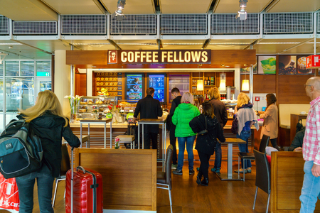 Munich, Germany - October 14, 2017: Passengers stand in a queue in a cafe at the airportのeditorial素材