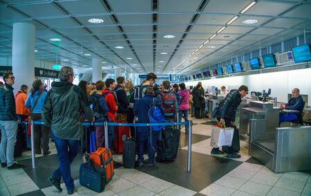 Munich, Germany - October 14, 2017: Passengers stand in line for check-in and transfer baggageのeditorial素材