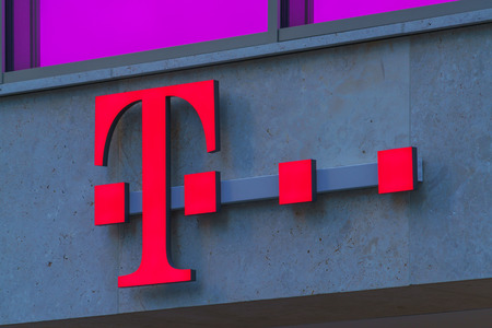 Munich, Germany - October 14, 2017: A sign with the logo of the telecommunications company T-mobileのeditorial素材