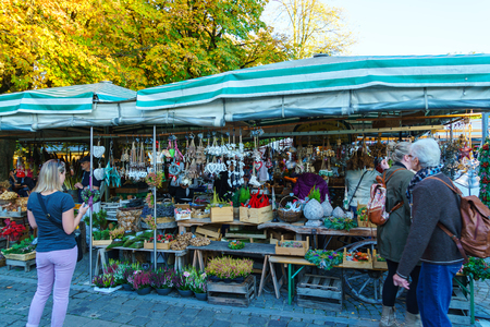 Munich, Germany - October 14, 2017: Tourists buy different kinds of souvenirs on the counter of the Viktualienmarkt marketのeditorial素材