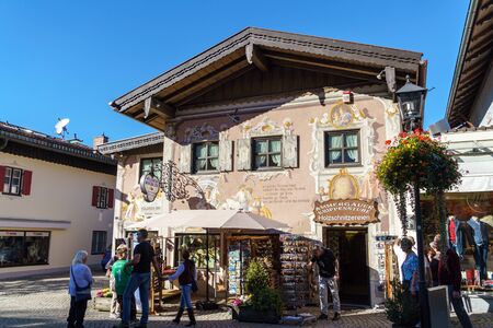 Obberamergau, Germany - October 15, 2017: Traditional homes with Luftlmalerei frescoes  and touristsのeditorial素材