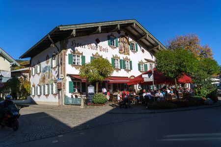 Obberamergau, Germany - October 15, 2017: Traditional homes with Luftlmalerei frescoes  and touristsのeditorial素材