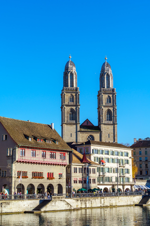 Embankment of river Limmat with Fraumunster and Grossmunster churches in warm light, Zurich, Switzerlandのeditorial素材