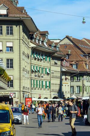 Bern, Switzerland - October 17, 2017: Tourists and locals on the streets of the old city surrounded by traditional houses and shopsのeditorial素材