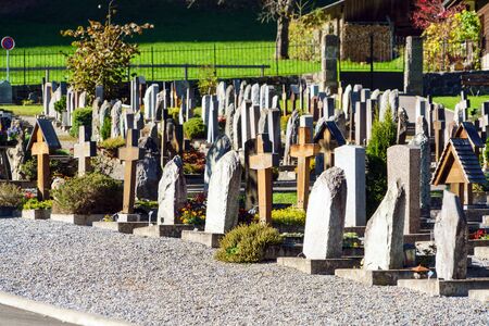 Lauterbrunnen, Switzerland - October 17, 2017: Traditional monuments, tombstones and crosses in the cemetery in Berner Oberland villageのeditorial素材