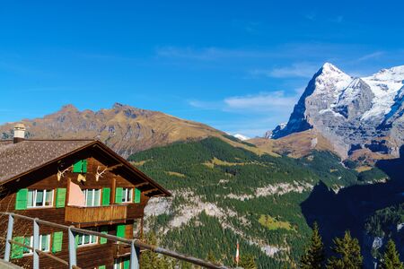 Murren, Switzerland - October 17, 2017: Traditional Chalet house and Alps mountains in Berner...