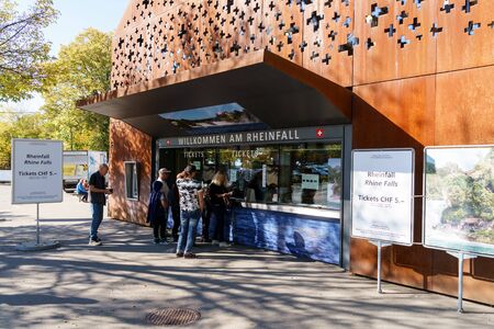 Neuhausen, Switzerland - October 16, 2017: Tourists buy tickets at the ticket office to visit the...