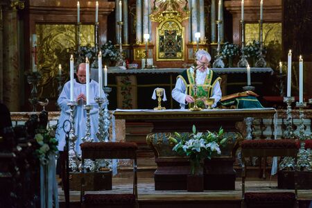 Vienna, Austria - October 22, 2017: The priest of the Roman Catholic Church serves Mass and prepares...