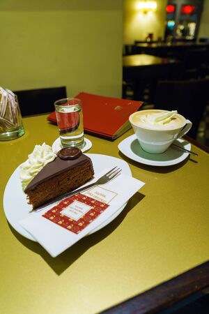 Graz, Austria - October 2w, 2017: On the table of the austrian confectionery cafe  Sacher cake and coffee mug with vienna cafeのeditorial素材