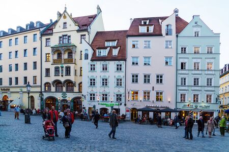 Munich, Germany - October 25, 2017:  Local residents walk through the streets of the old city next to the signs of beer restaurantsのeditorial素材