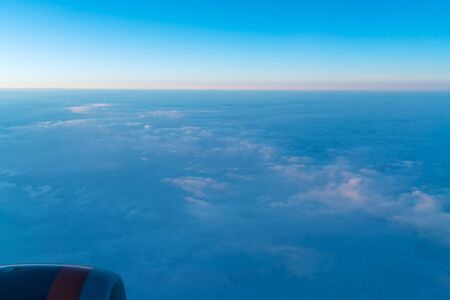 Abstract background with beautiful clouds at sunrise taken from an airplane window