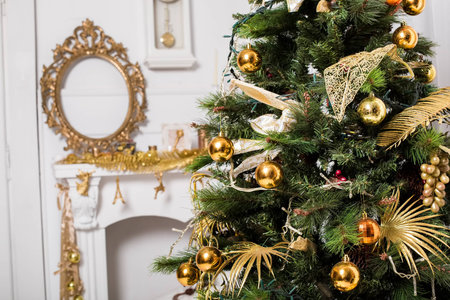 christmas decorated room with a tree and a mantelpieceの写真素材