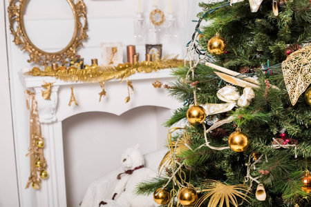 christmas decorated room with a tree and a mantelpieceの写真素材
