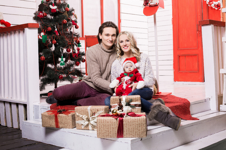 christmas family in a christmas decorated room with a christmas treeの写真素材