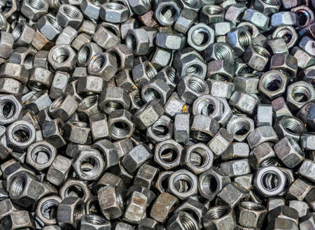 Top view of big pile of screw nuts as backgroundの写真素材