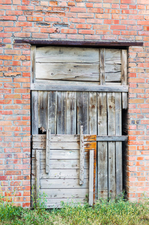 Boarded up doorway in brick wallの写真素材
