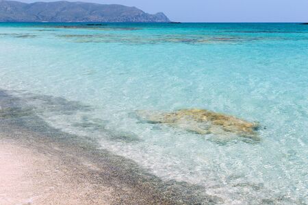Coast of Crete island in Greece. Sandy beach with transparent clean water azure colorの写真素材