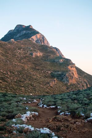 The trail to the mountain is marked white stones. Balos beach in Crete, Greeceの写真素材