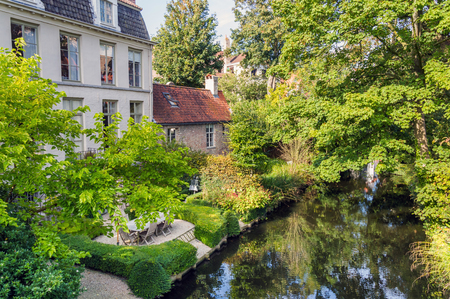 Beautiful inner yard on the bank of canal in town of Bruges, Belgiumの写真素材
