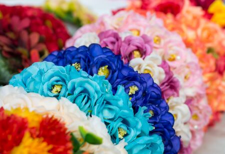 Bright and beautiful colors of plastic flowers. Blur backgroundの写真素材