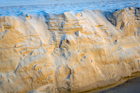 Sand texture of the colored sand cliffs on beach.