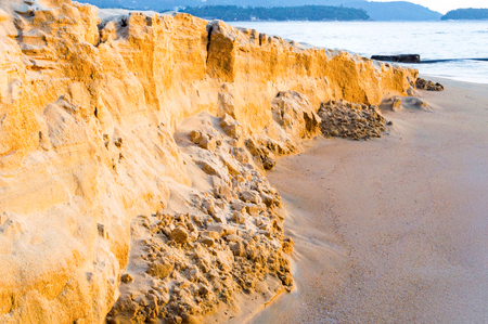 Sand texture of the colored sand cliffs on beach.の写真素材