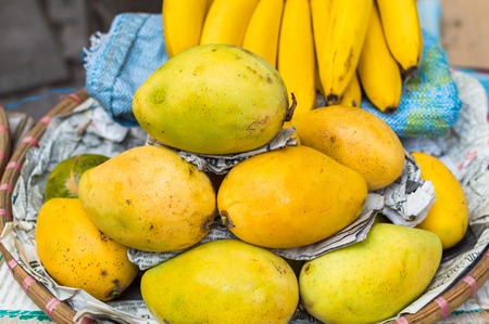 Fresh fruit market in Asia. Mango in the bucket. Exotic street foodの写真素材