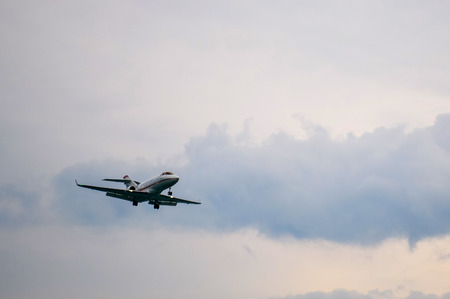 Airplane flying in cloudy sky.の写真素材