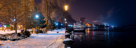 Night view from the embankment of Rostov-on-Don on river Don to the east. River cruise ship in winter mooring.の写真素材
