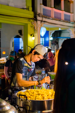 Phuket, Thailand - February, 02, 2017: Unidentified asian men sells food on old Town Phuket Festivalのeditorial素材