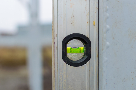 Magnet water bubble level gauge on steel beam at construction site for measuring, check level of the...