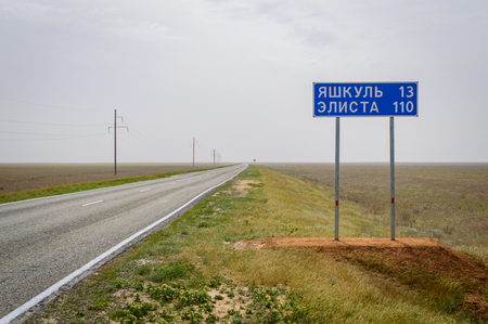 Road signpost of the distance to the city of Yashkul 13 and Elista 110 km on Russianの写真素材