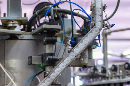 Plastic caps in corking device at winery.の写真素材