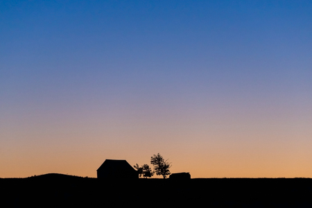 Gradient sunrise sky showing blue, yellow and orange layer.の写真素材